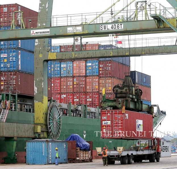 A container being lowered down from the MV MTT Muara to a trailer truck during Wednesday’s welcome ceremony. 